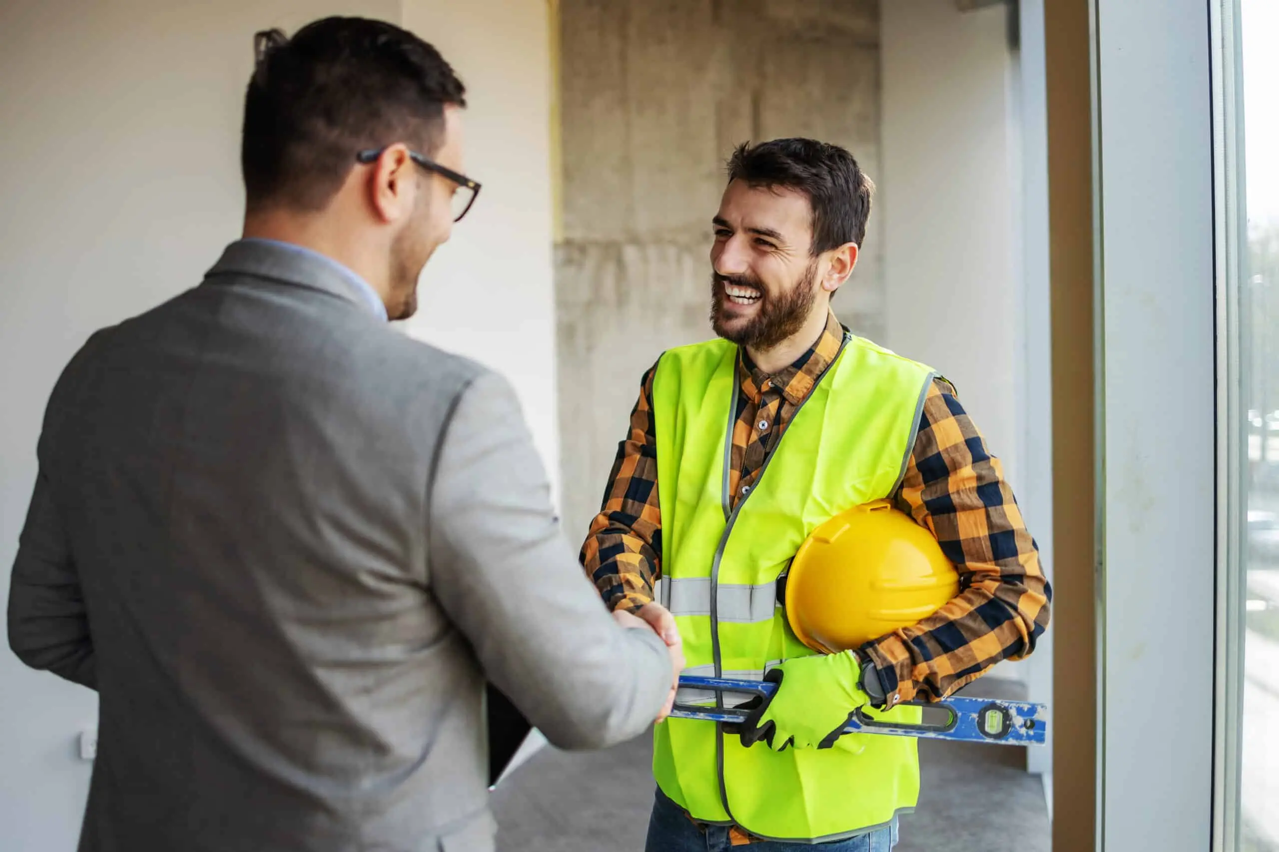 Construction contractor reviewing plans on an active job site