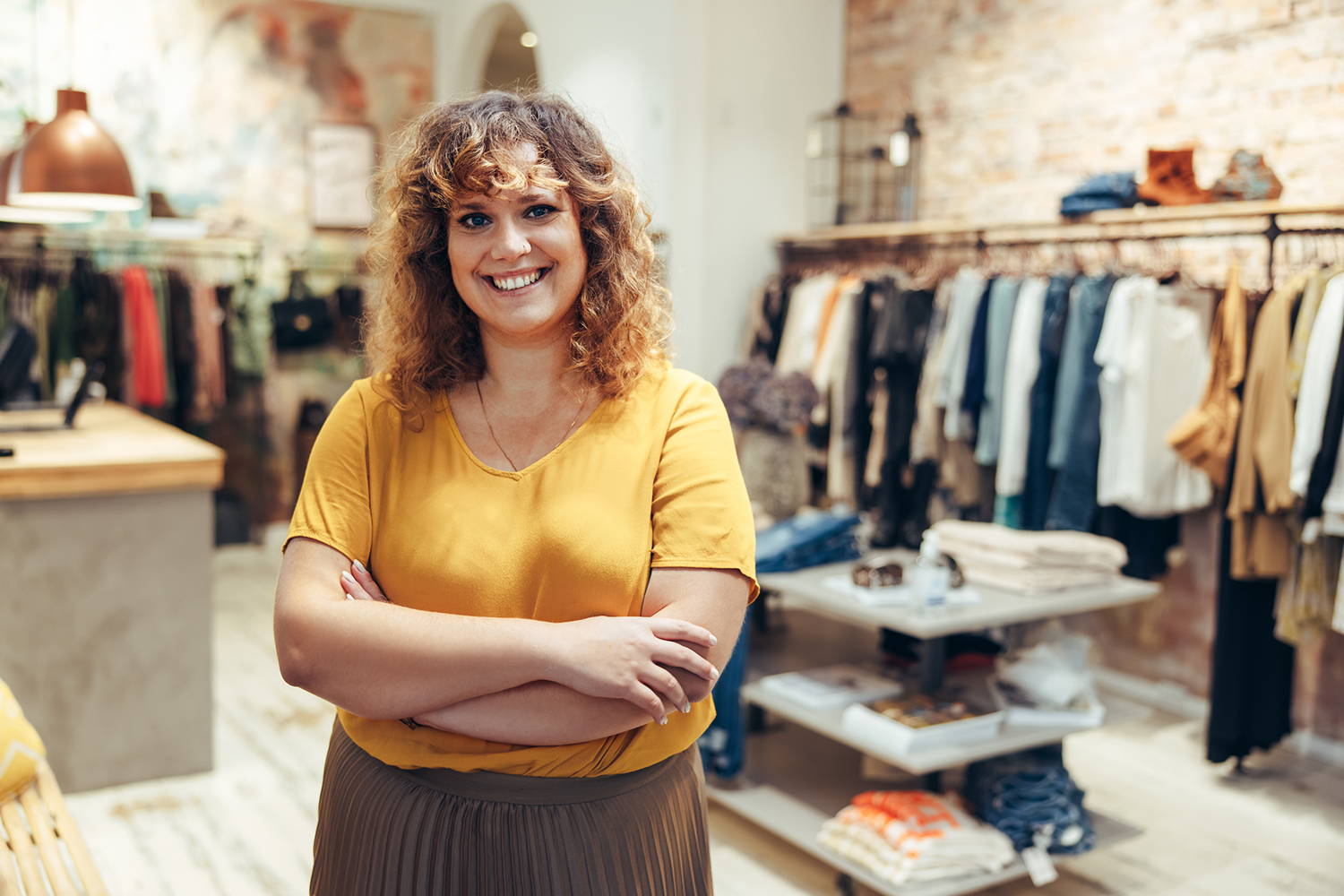 Retail store owner organizing merchandise on display shelves